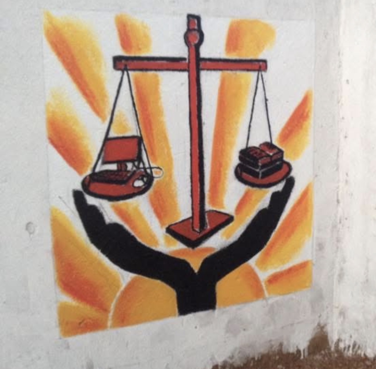 School emblem mural — scales, cross, and hands with sunrays