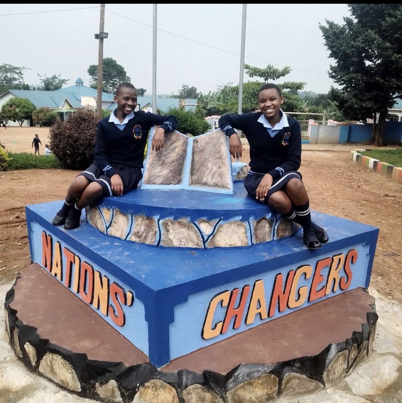 Two students sitting together at the monument